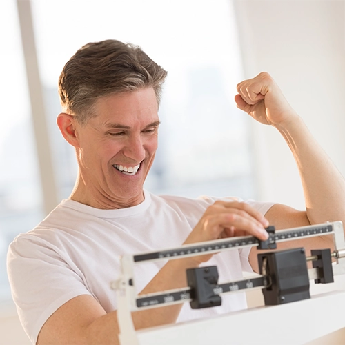 Chiropractic Verona WI Weight Loss Man On Scale